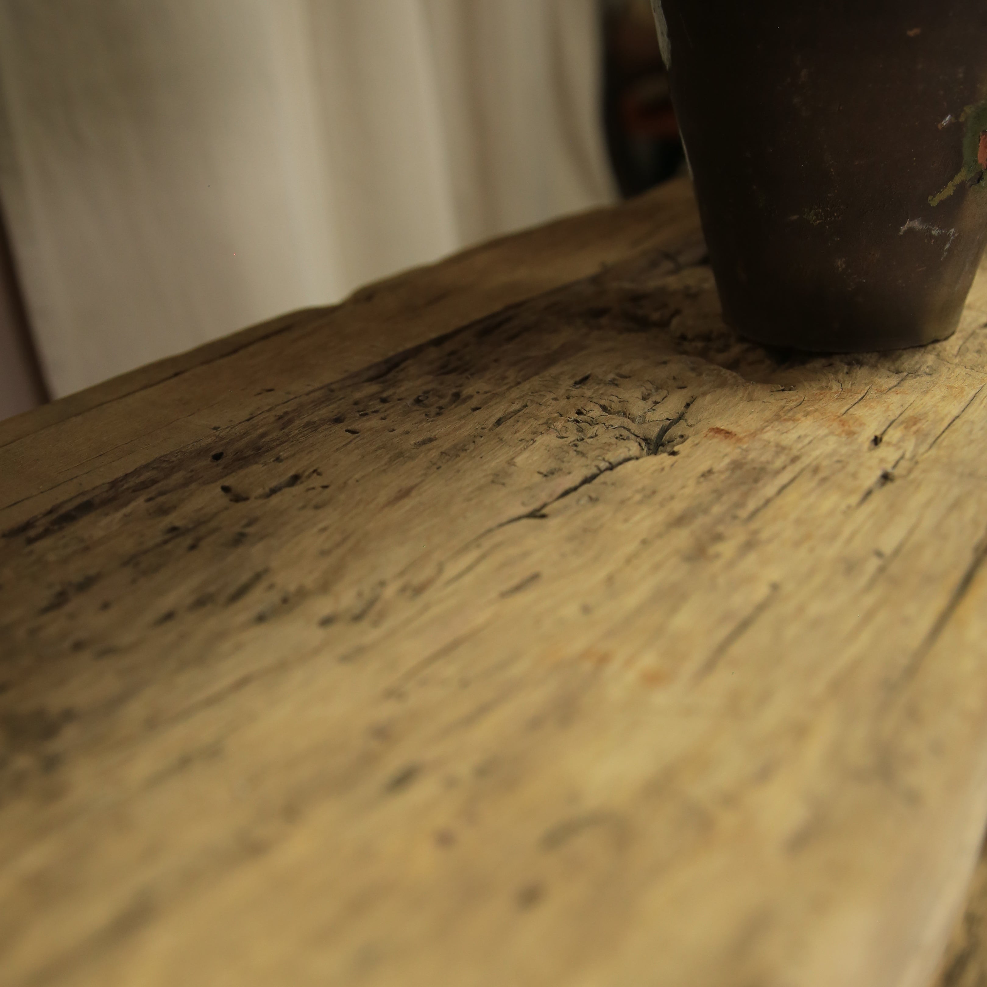 Close-up of a worn book corner with visible text and a dark object on top