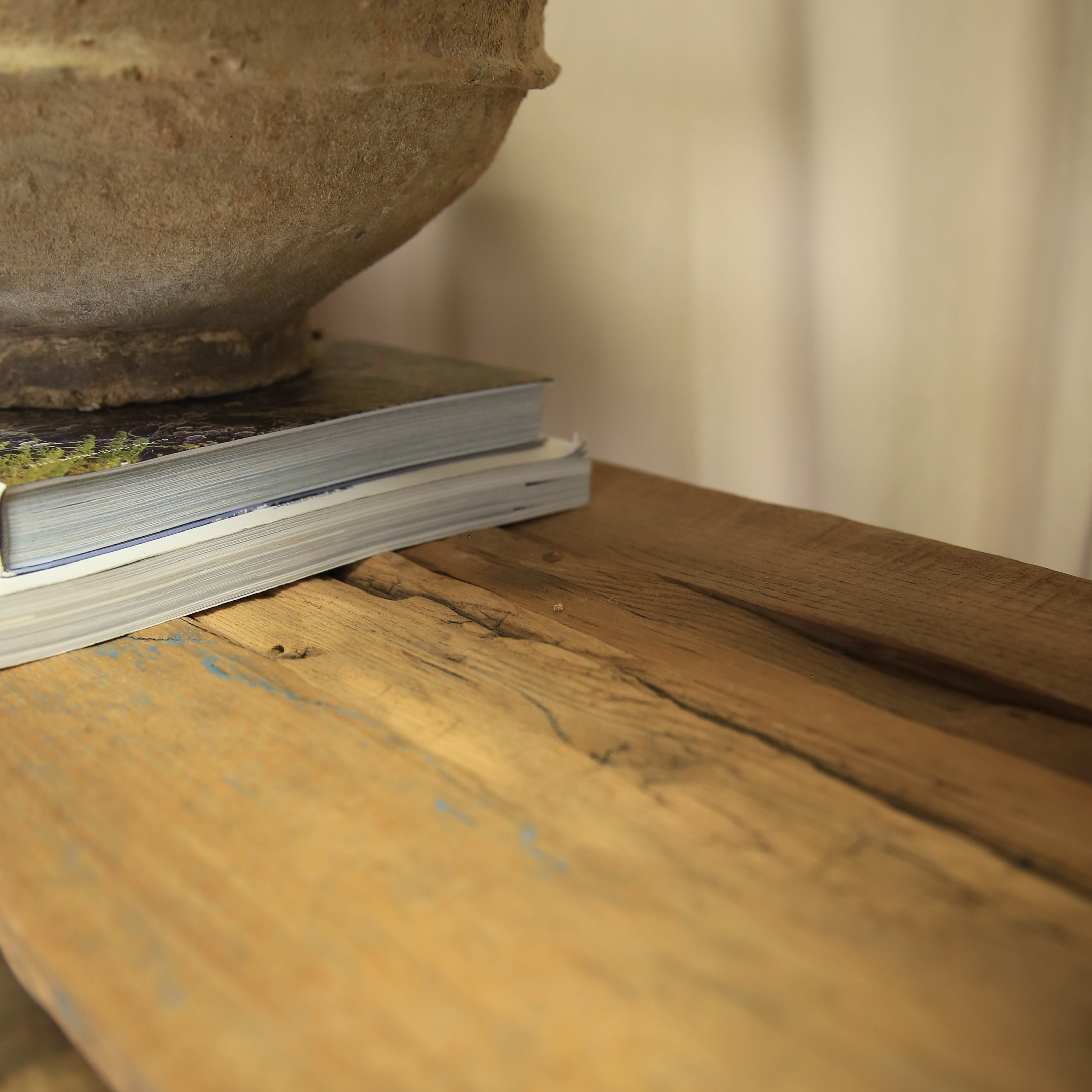 Close-up of a wooden surface with a metal object on top