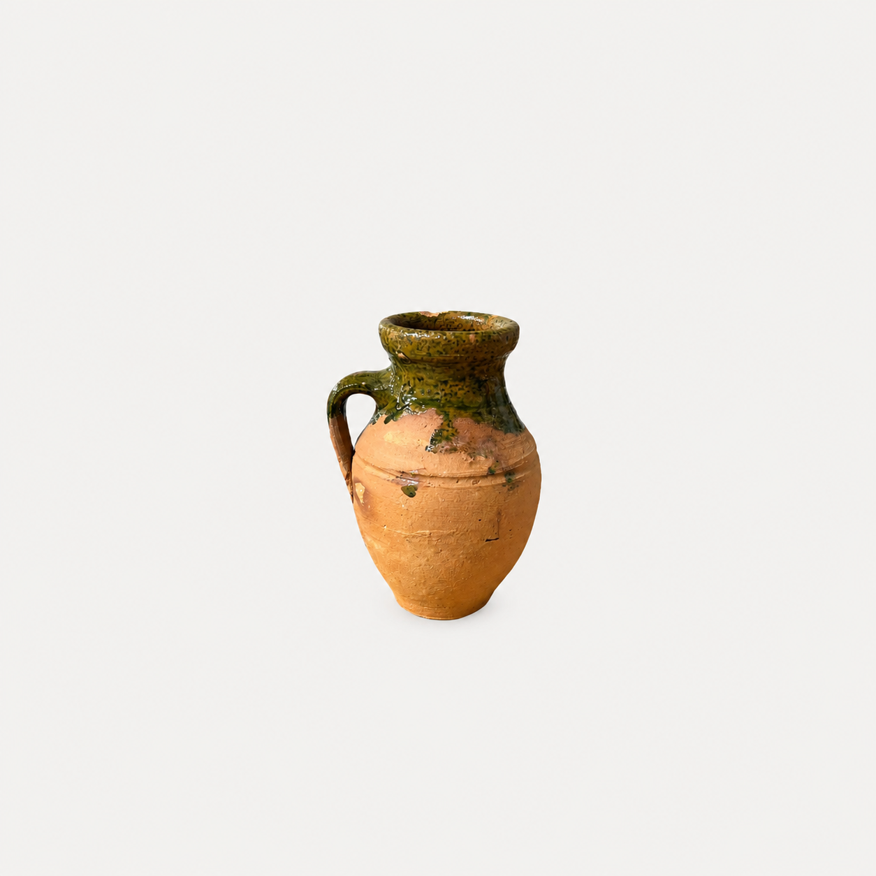 Ceramic vase with green top and brown body on a white background