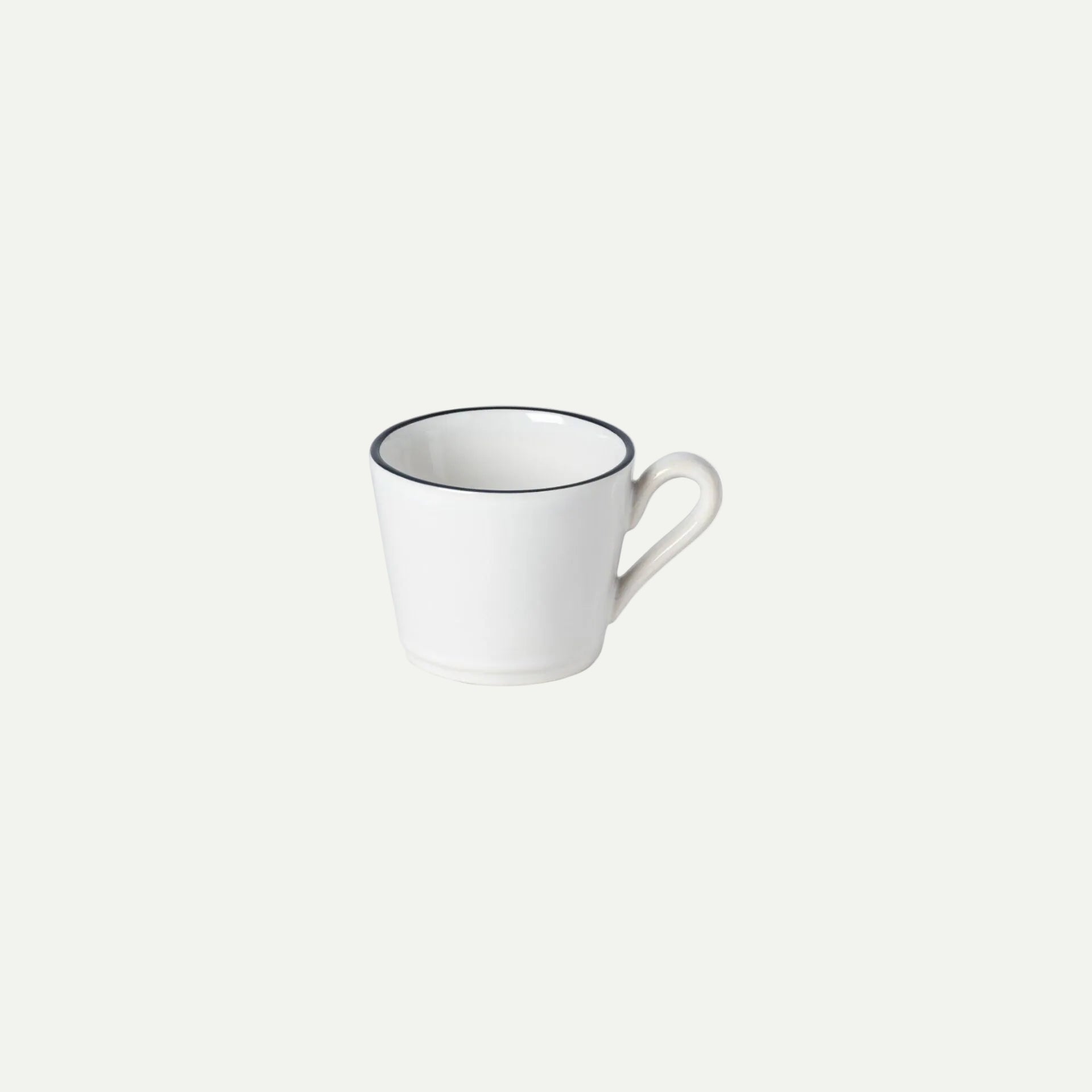 White mug with black rim on a white background