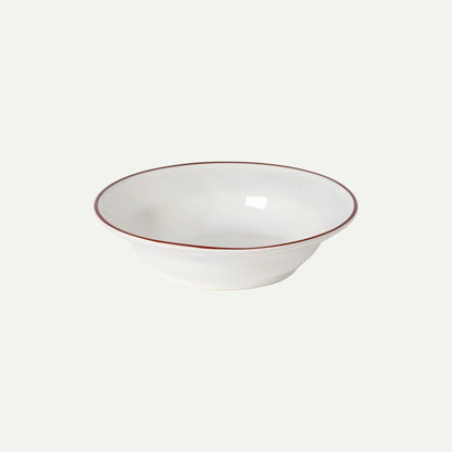 White ceramic bowl with a thin brown rim on a white background
