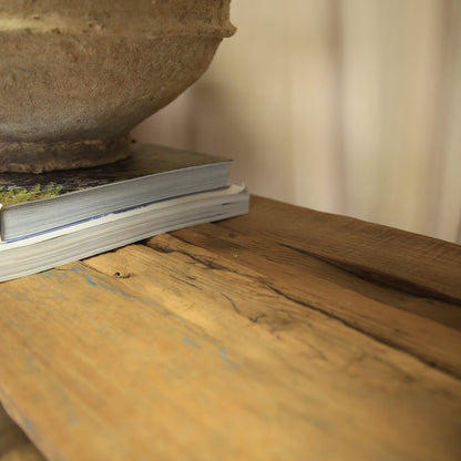 Close-up of a wooden surface with a metal object on top