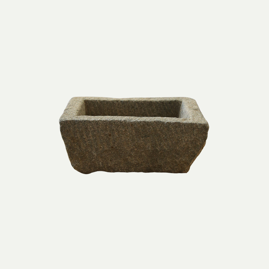 Rectangular stone trough with a rough, textured surface and deep basin, suitable for use as a planter, decorative piece, or rustic garden feature.