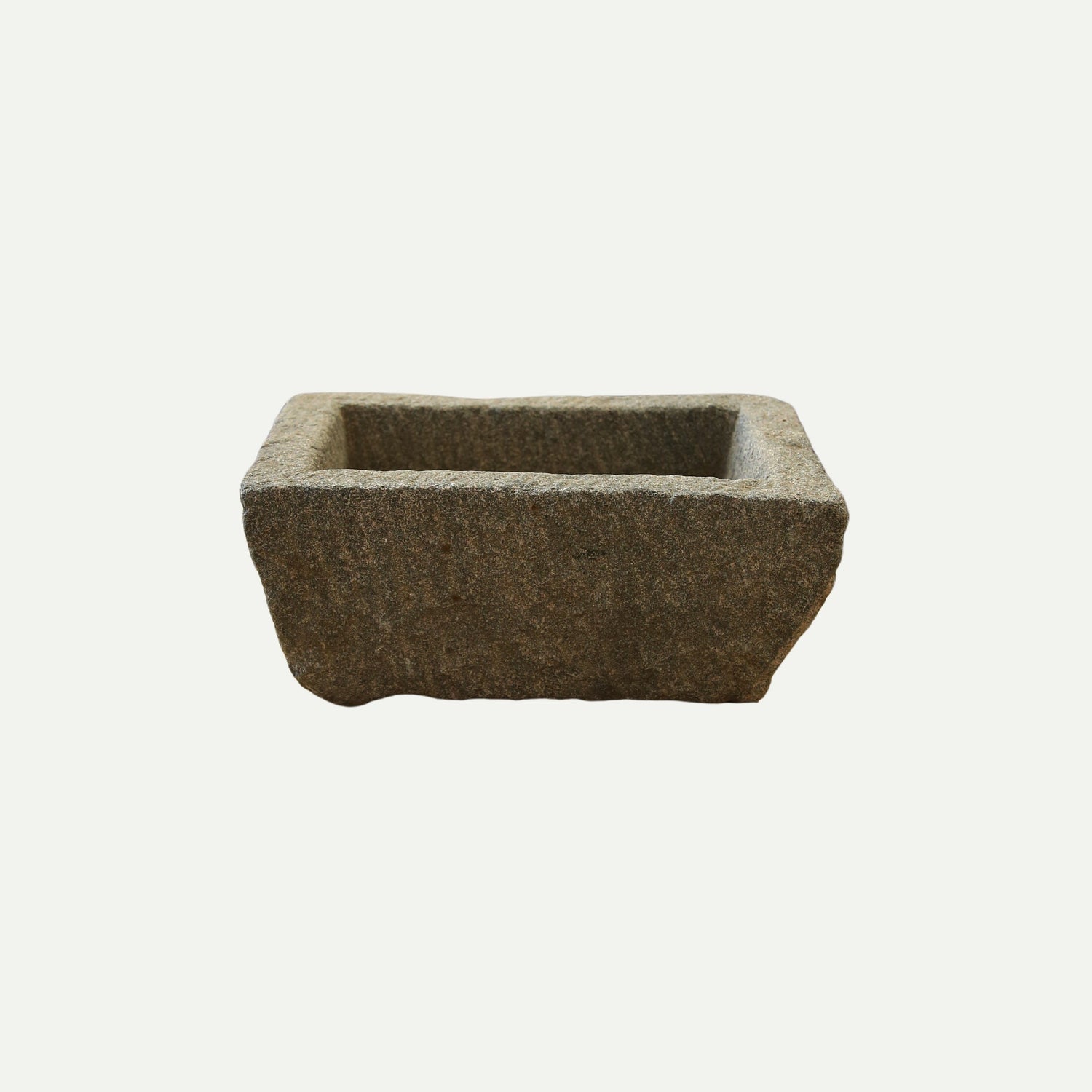 Rectangular stone trough with a rough, textured surface and deep basin, suitable for use as a planter, decorative piece, or rustic garden feature.