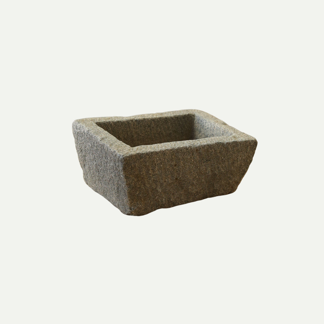 Rectangular stone trough with a rough, textured surface and deep basin, suitable for use as a planter, decorative piece, or rustic garden feature.