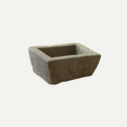 Rectangular stone trough with a rough, textured surface and deep basin, suitable for use as a planter, decorative piece, or rustic garden feature.