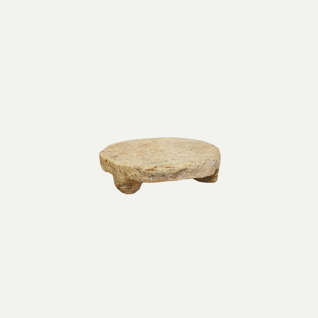 Rustic round wood riser with a natural, weathered finish and three short legs, designed for home decor or display purposes.