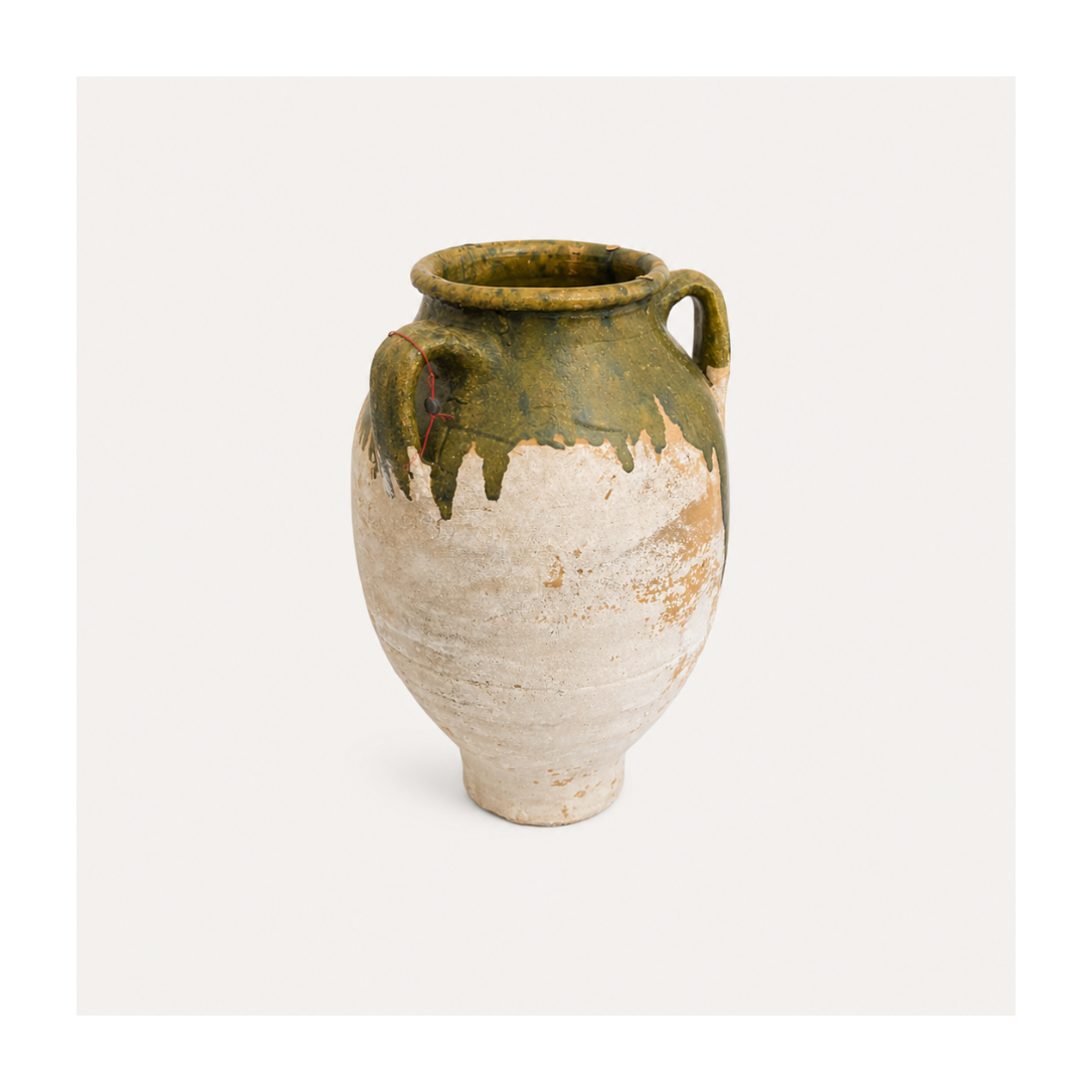 Vintage ceramic vase with green top and white base on a light gray background