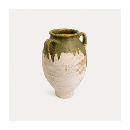 Vintage ceramic vase with green top and white base on a light gray background